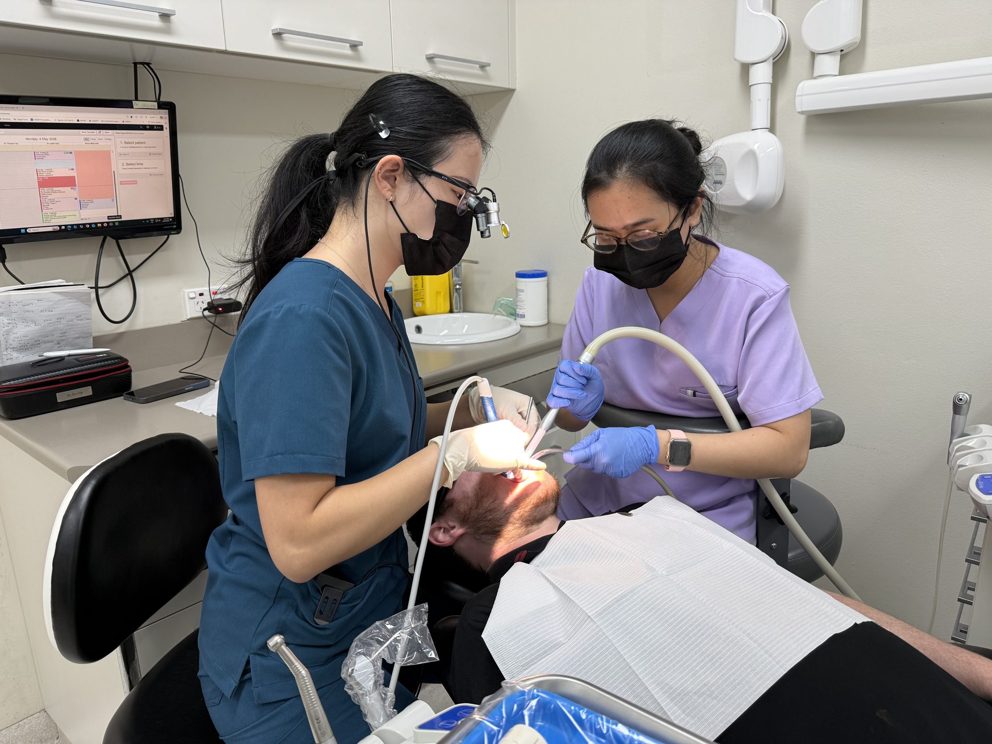 Ceres Dental clinicians treating a patient in a modern treatment room